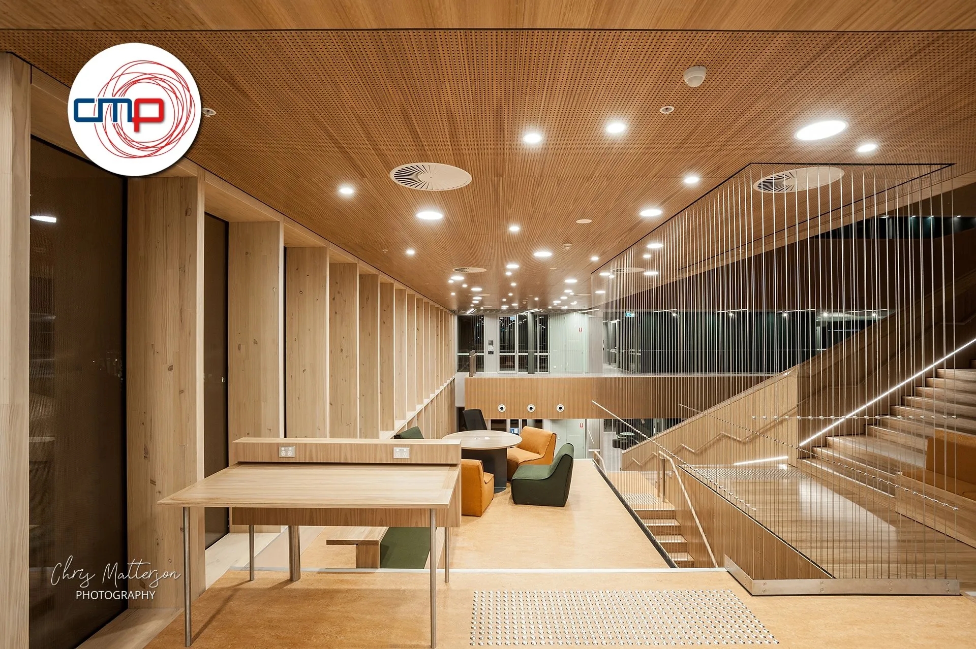 Modern office interior with wood panelling and staircase